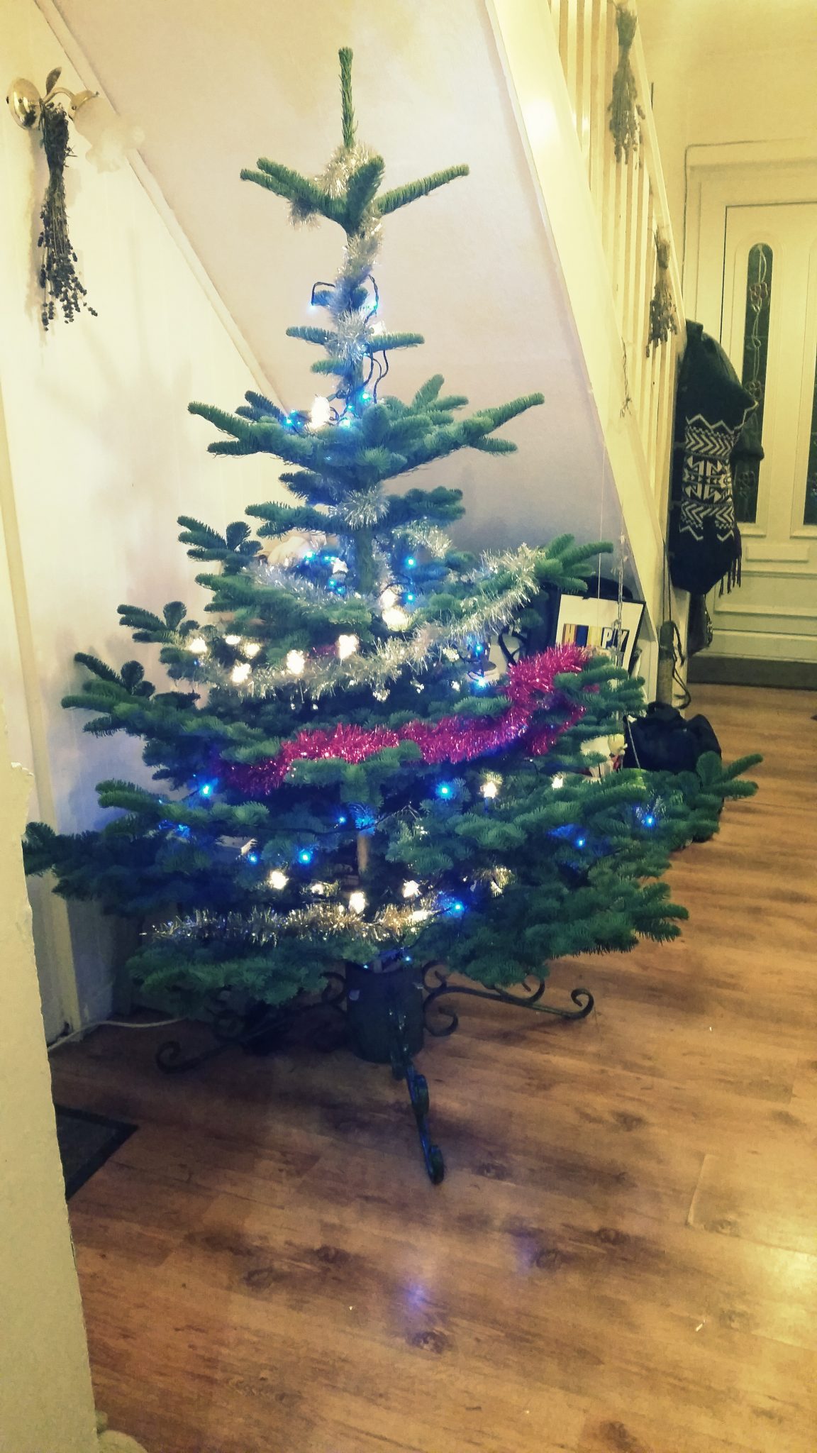 6. Plug both sets of lights in behind the tree and then wrap them round and round from bottom to top