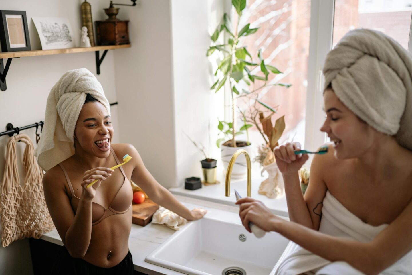 Two women practising natural dentistry and holistic dental health in an eco-friendly bathroom